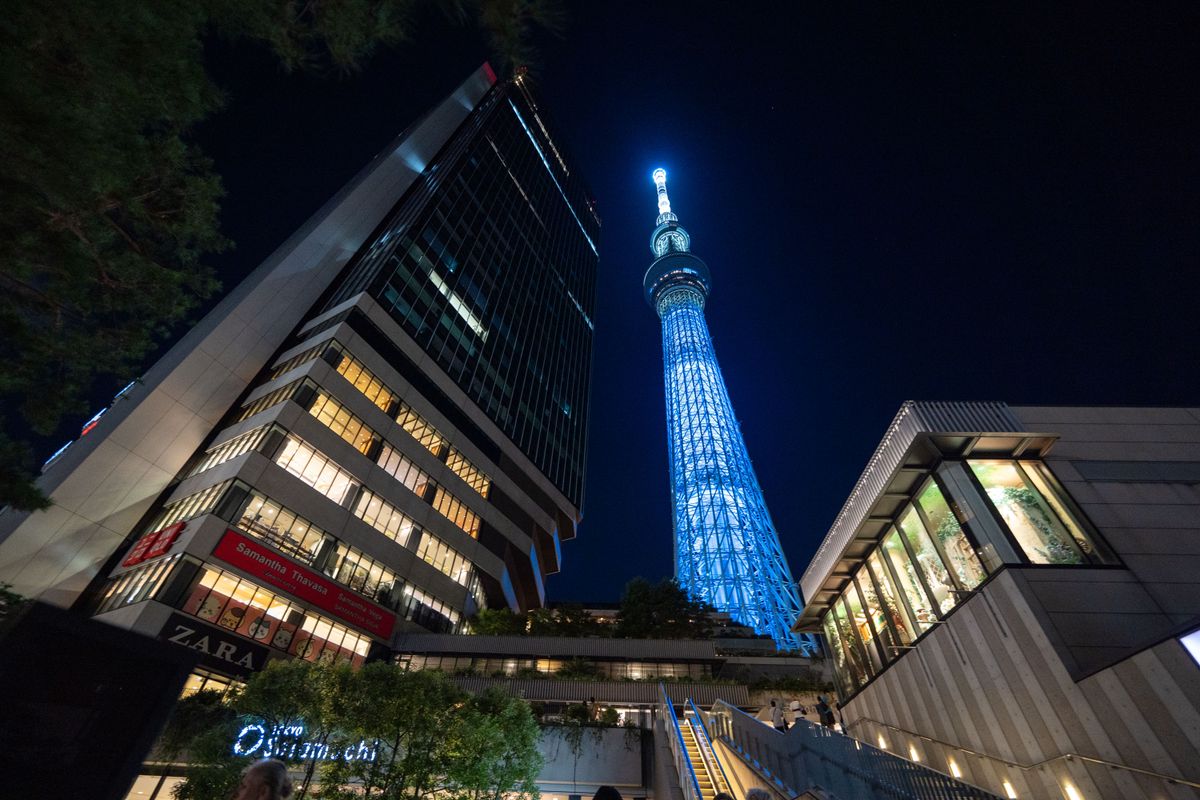 Dramatic night view of the illuminated Tokyo Skytree and surrounding cityscape.